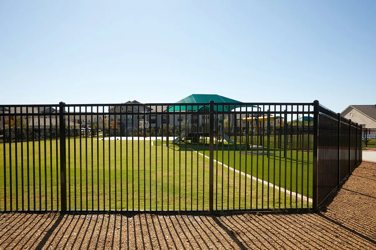 Black aluminum fence along a residential yard