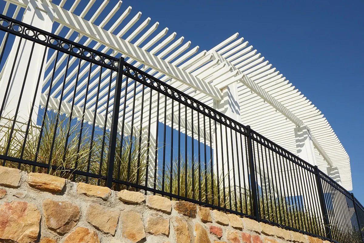 Black Fortress ornamental steel fence on a stone wall