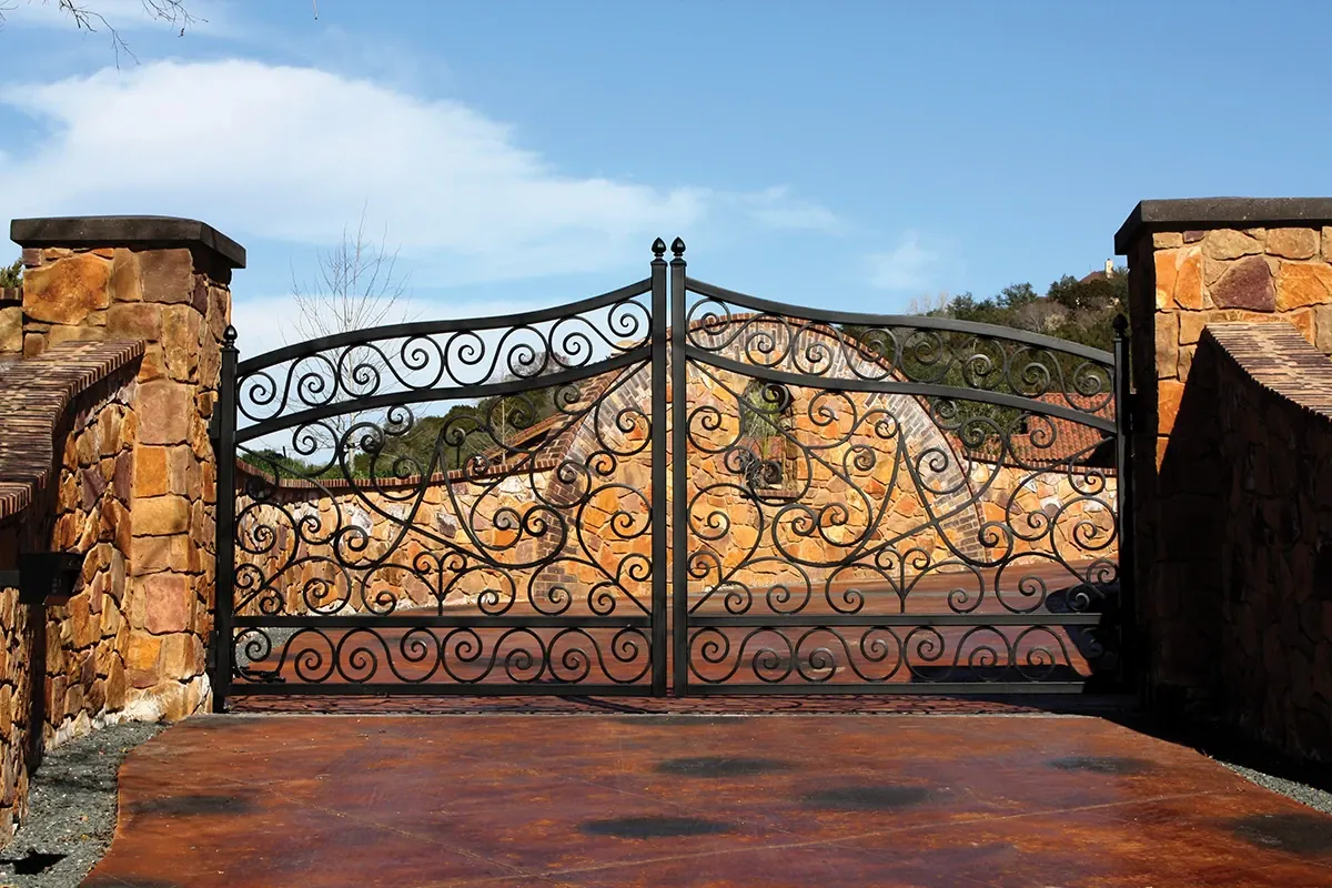 Scrolled ornamental Fortress gate between stone pillars