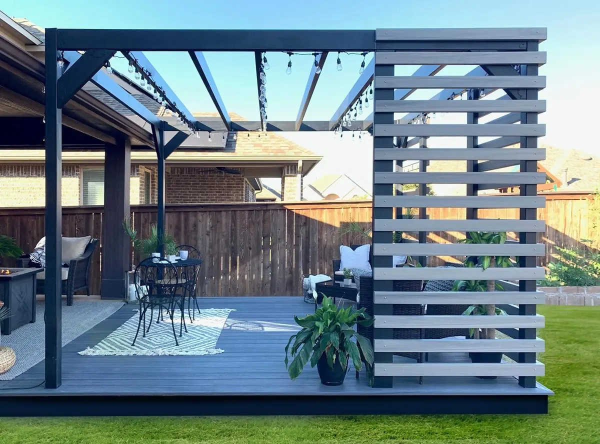 Fortress steel pergola with a privacy wall over a gray deck
