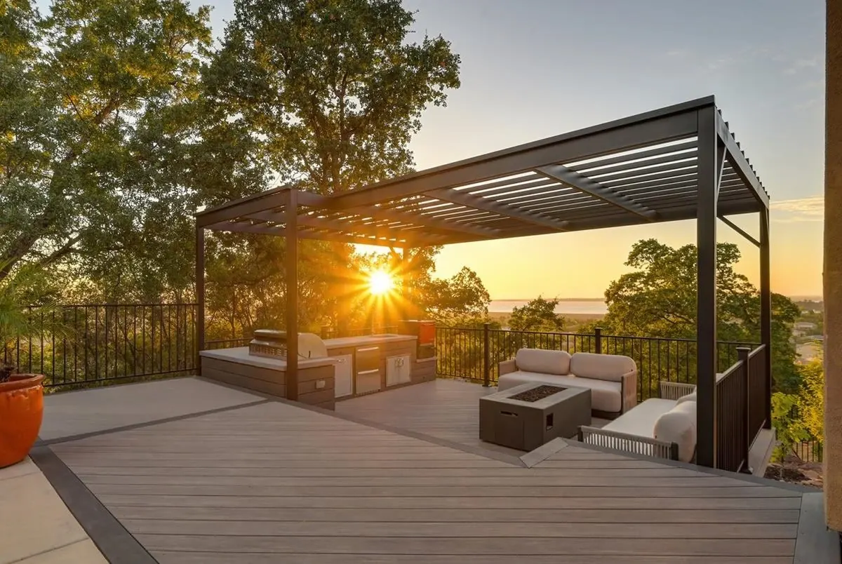 Steel pergola at sunset over a backyard deck