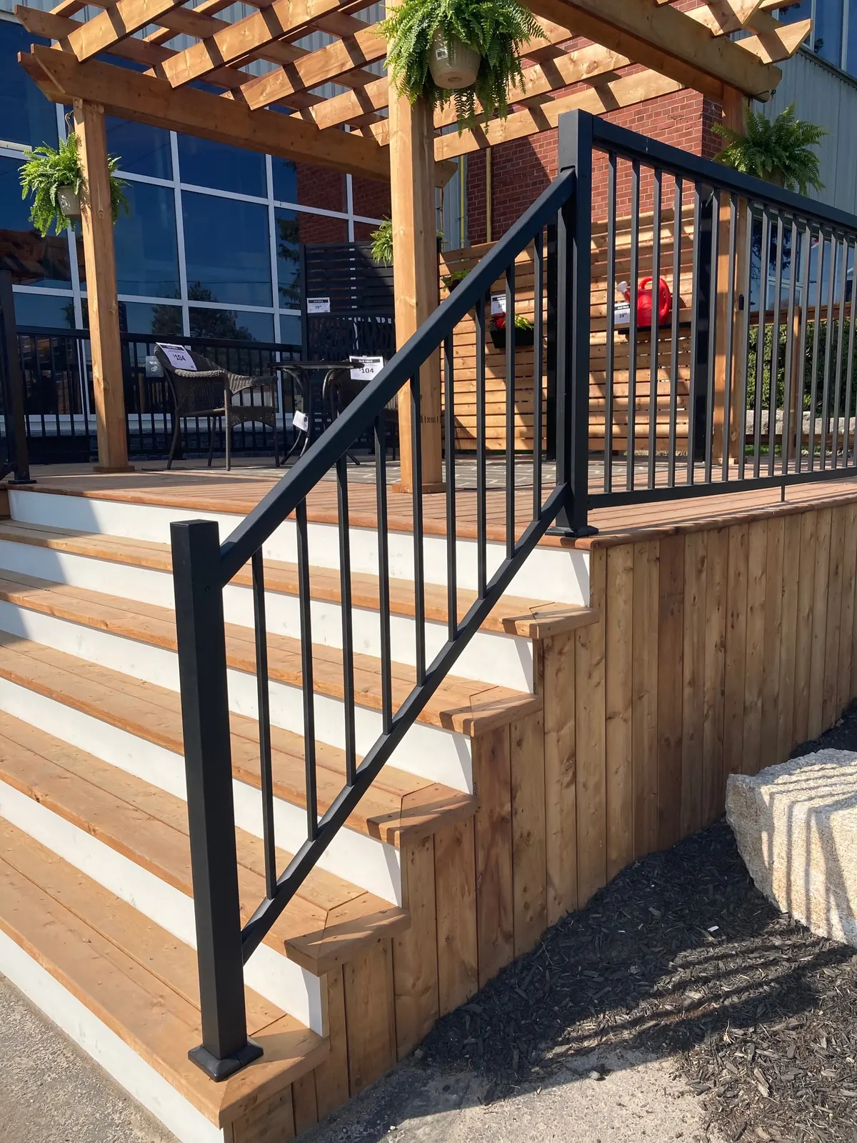 Black Vista aluminum stair railing on wood deck steps