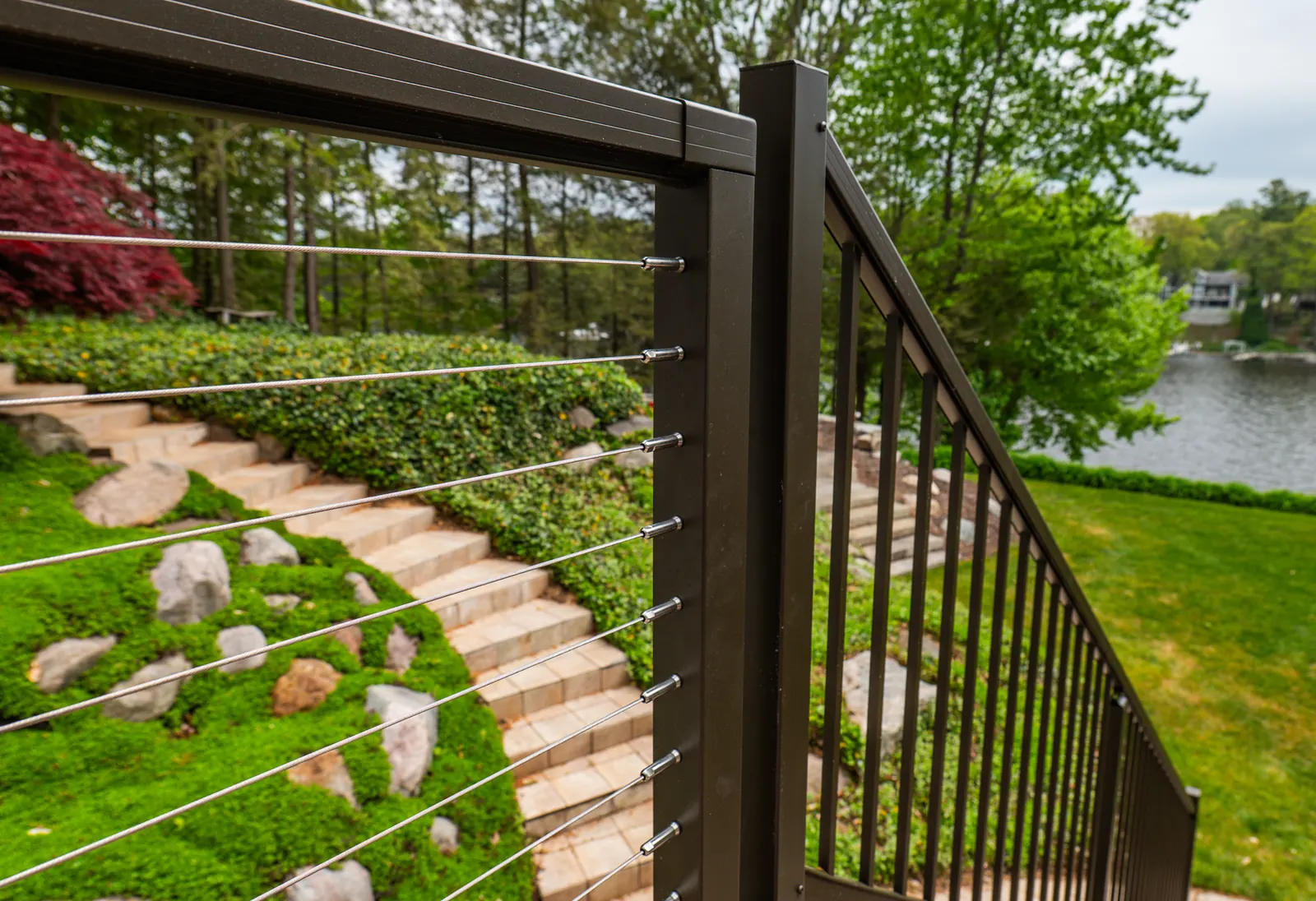 Close view of black Vista cable railing above garden steps