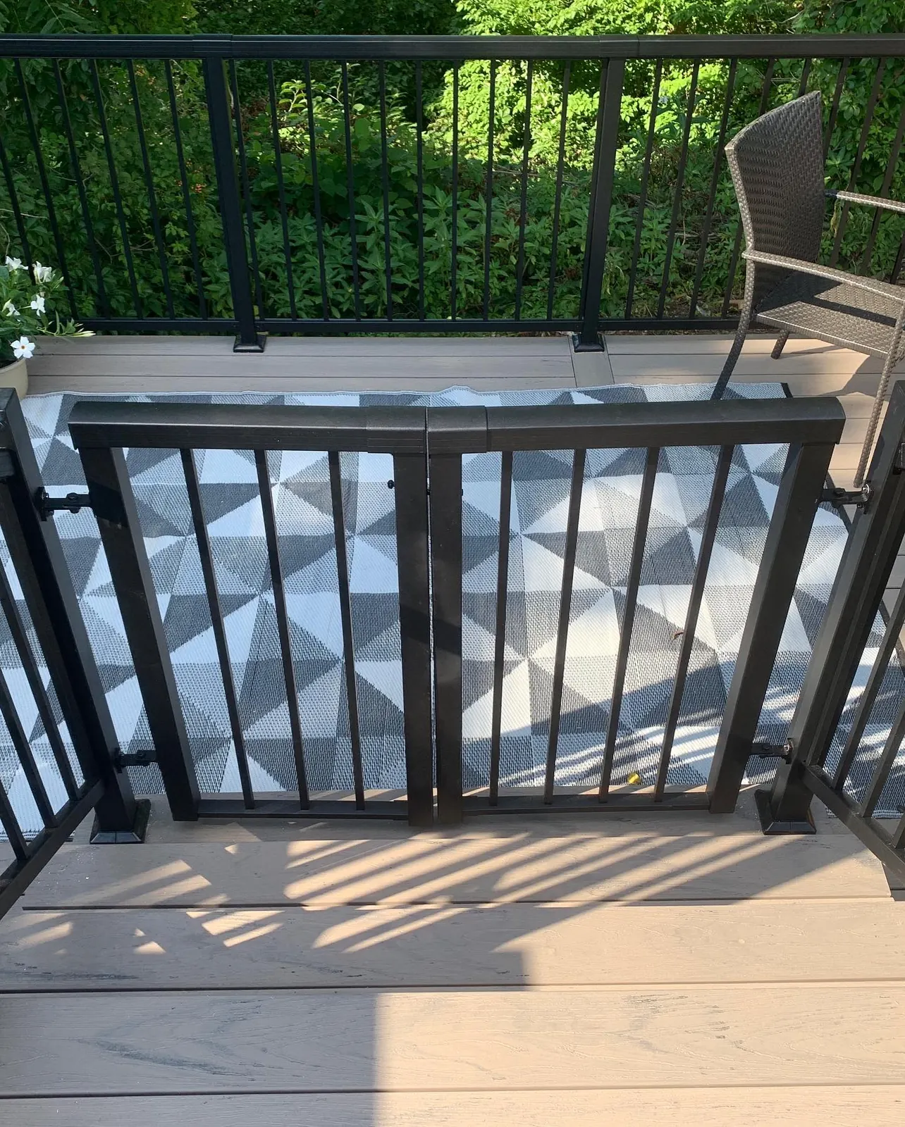 Black Vista double gate in a picket railing on a deck