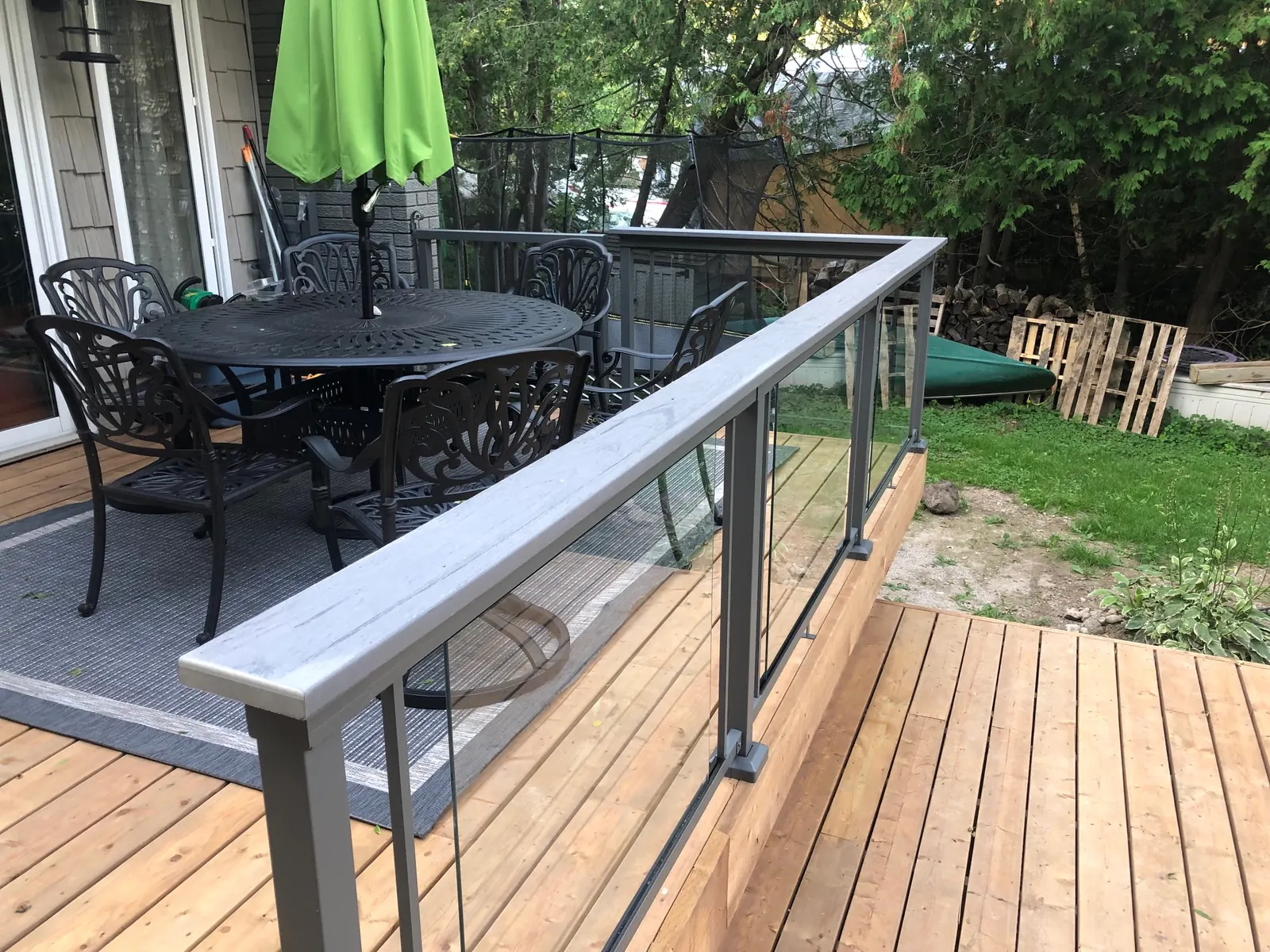 Vista framed glass railing with a composite drink rail on a patio deck