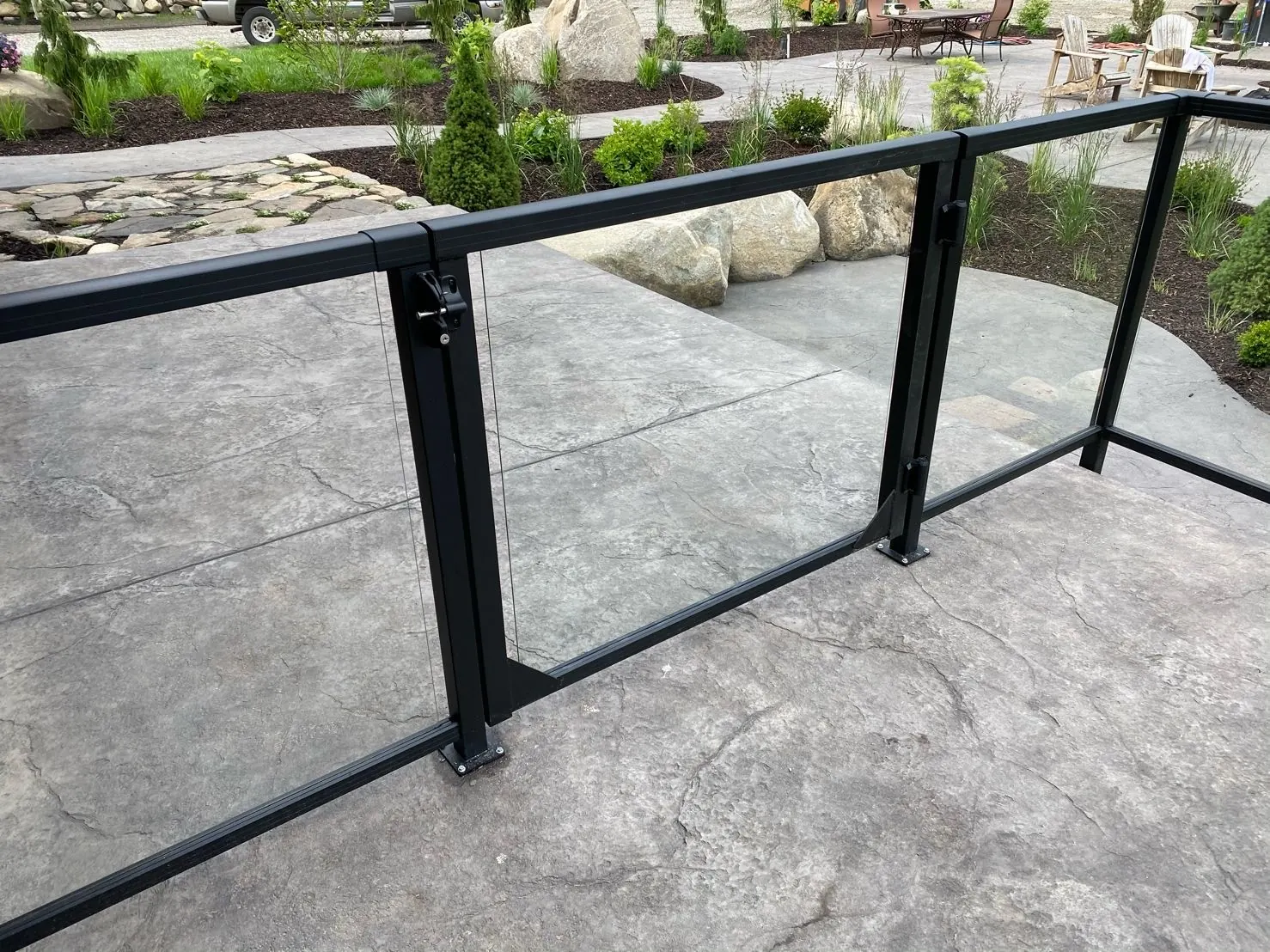 Vista framed glass gate on a stamped concrete patio