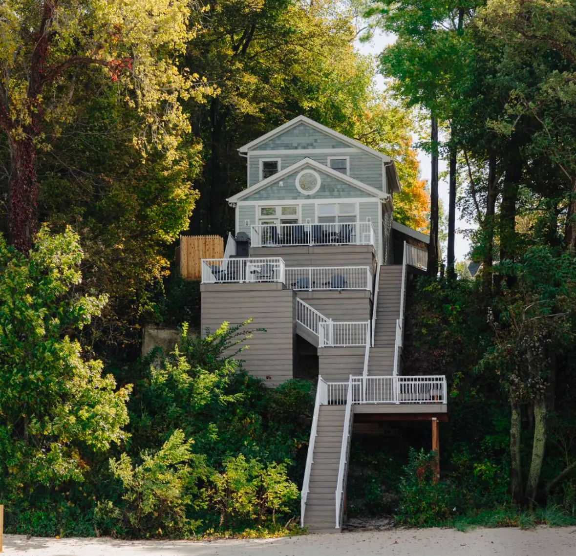 Hillside home with white Vista picket railing on decks and stairs