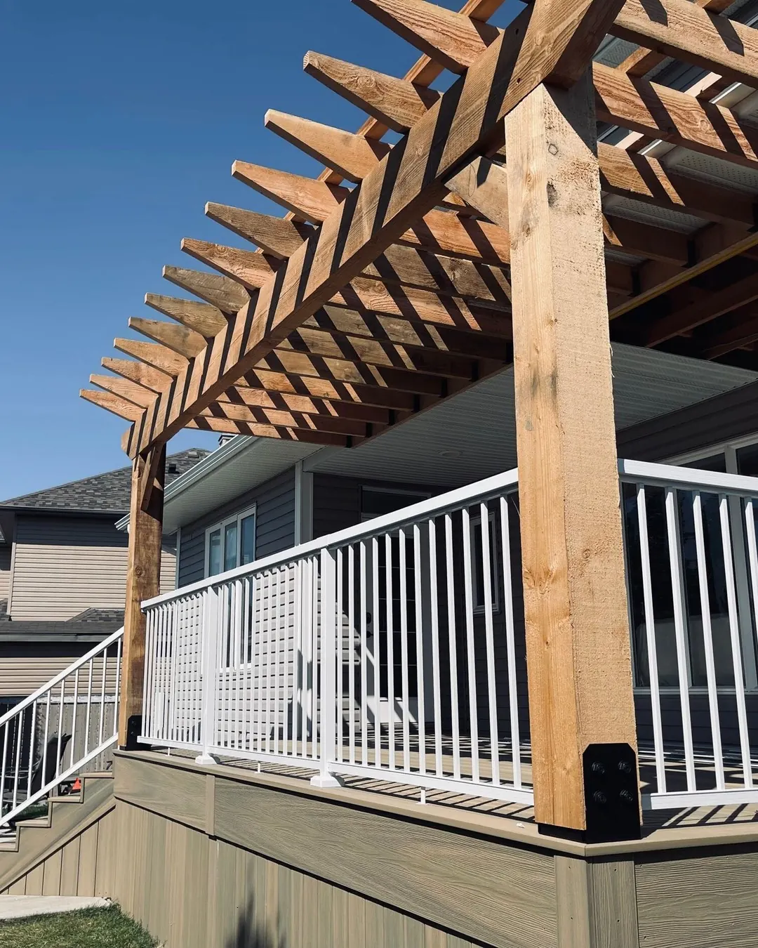 White Vista picket railing under a cedar pergola