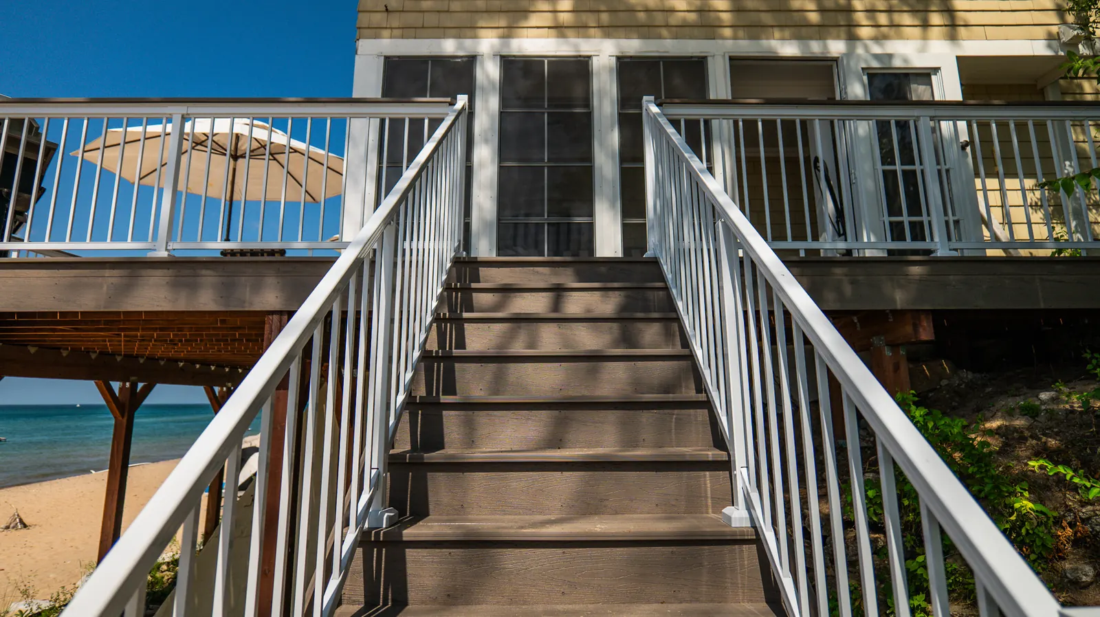 White Vista picket stair railing leading to a beach deck