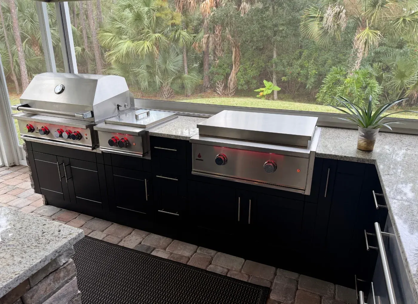 Black WeatherStrong outdoor kitchen with grill and griddle in a lanai
