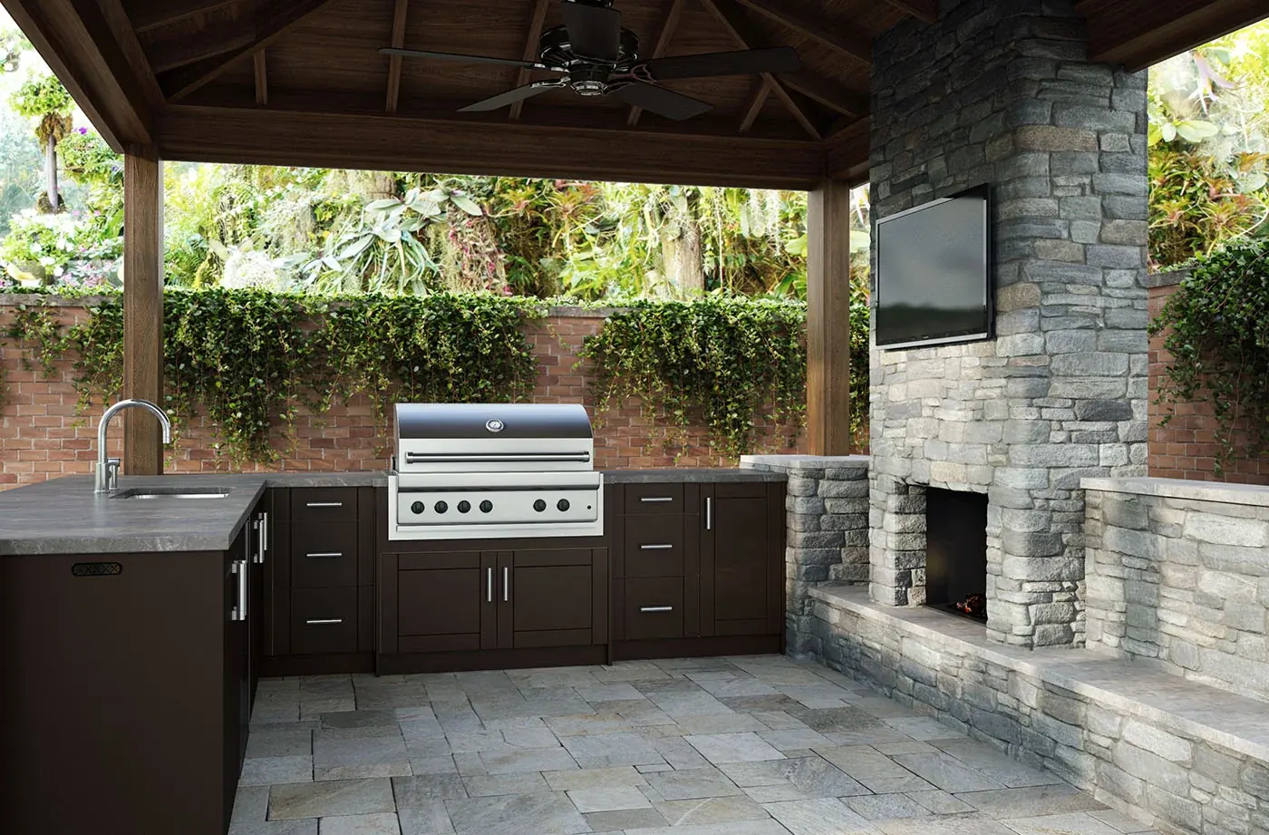 WeatherStrong kitchen under a pavilion beside a stone fireplace