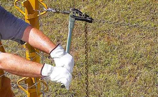 Installer tensioning fence wire with a stretcher tool