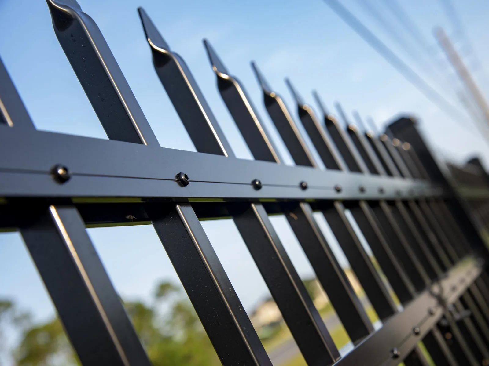 Close-up of aluminum fence spear tops and rivets
