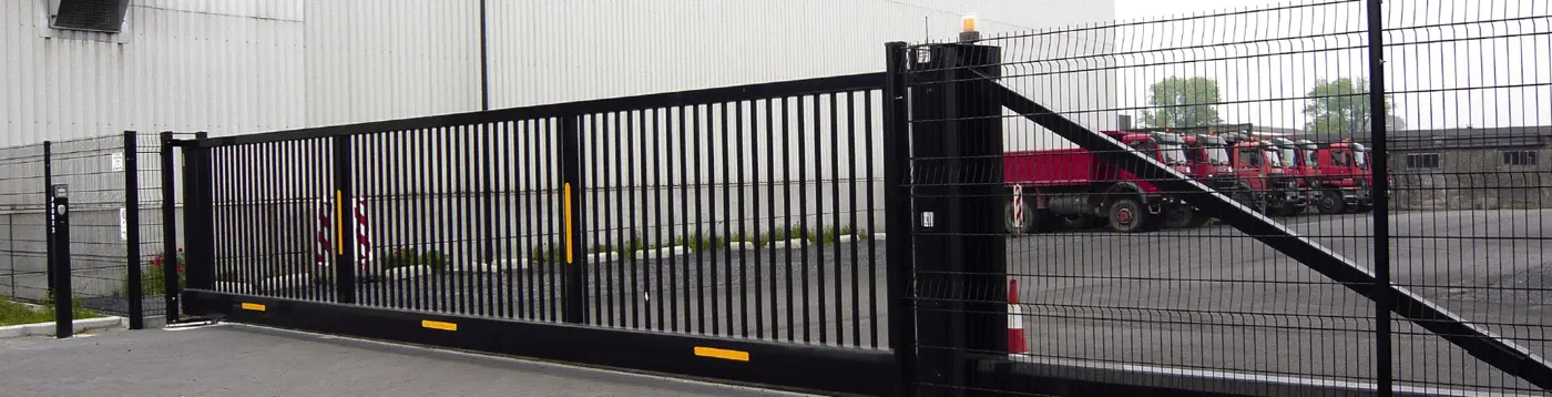 Black cantilever roll gate at an industrial site