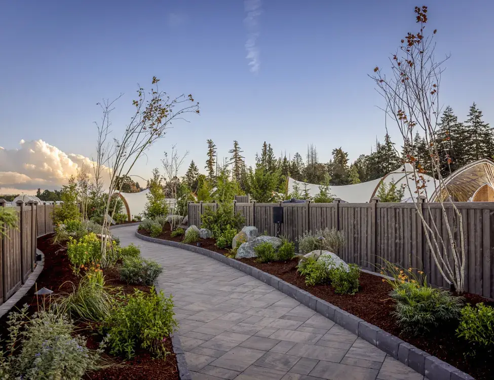 wood grain molded privacy fence along a paved path