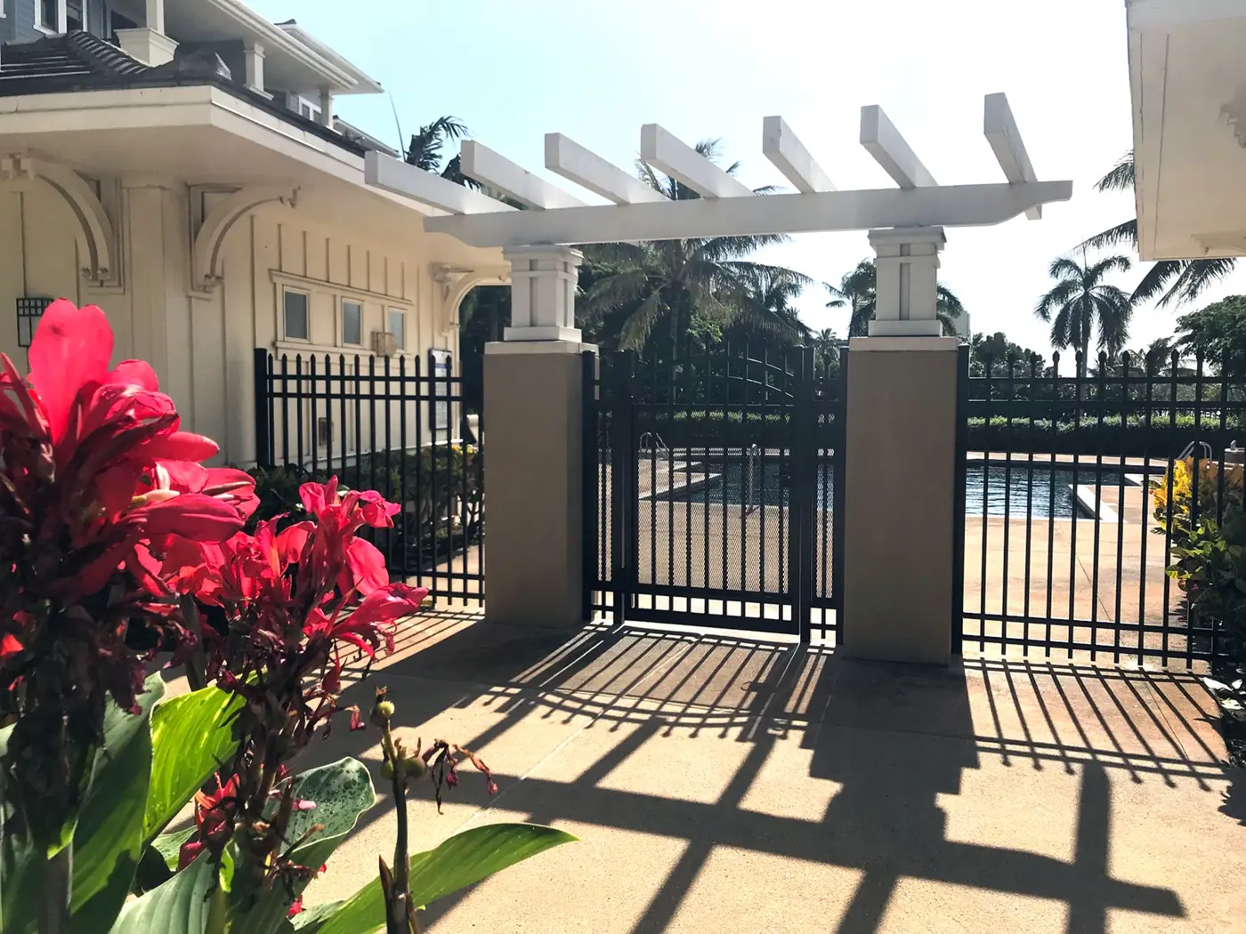 Catalyst commercial walk gate in an aluminum fence at a pool entrance