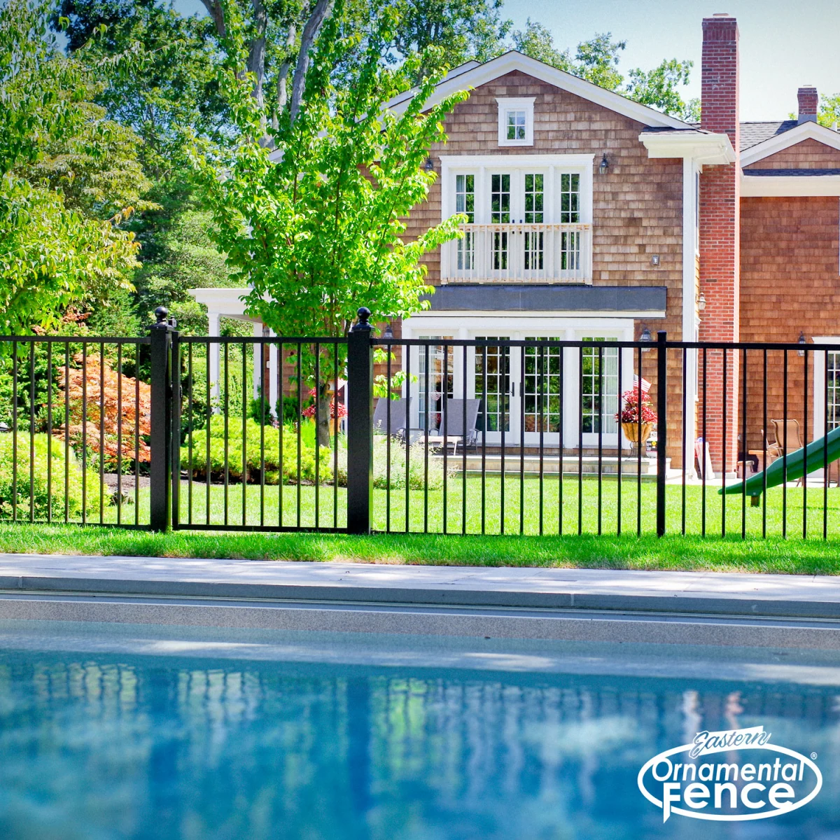 Eastern Ornamental Ovation two-rail fence by a pool