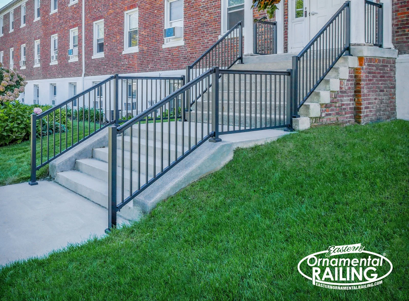 Aluminum stair railing beside a concrete walk