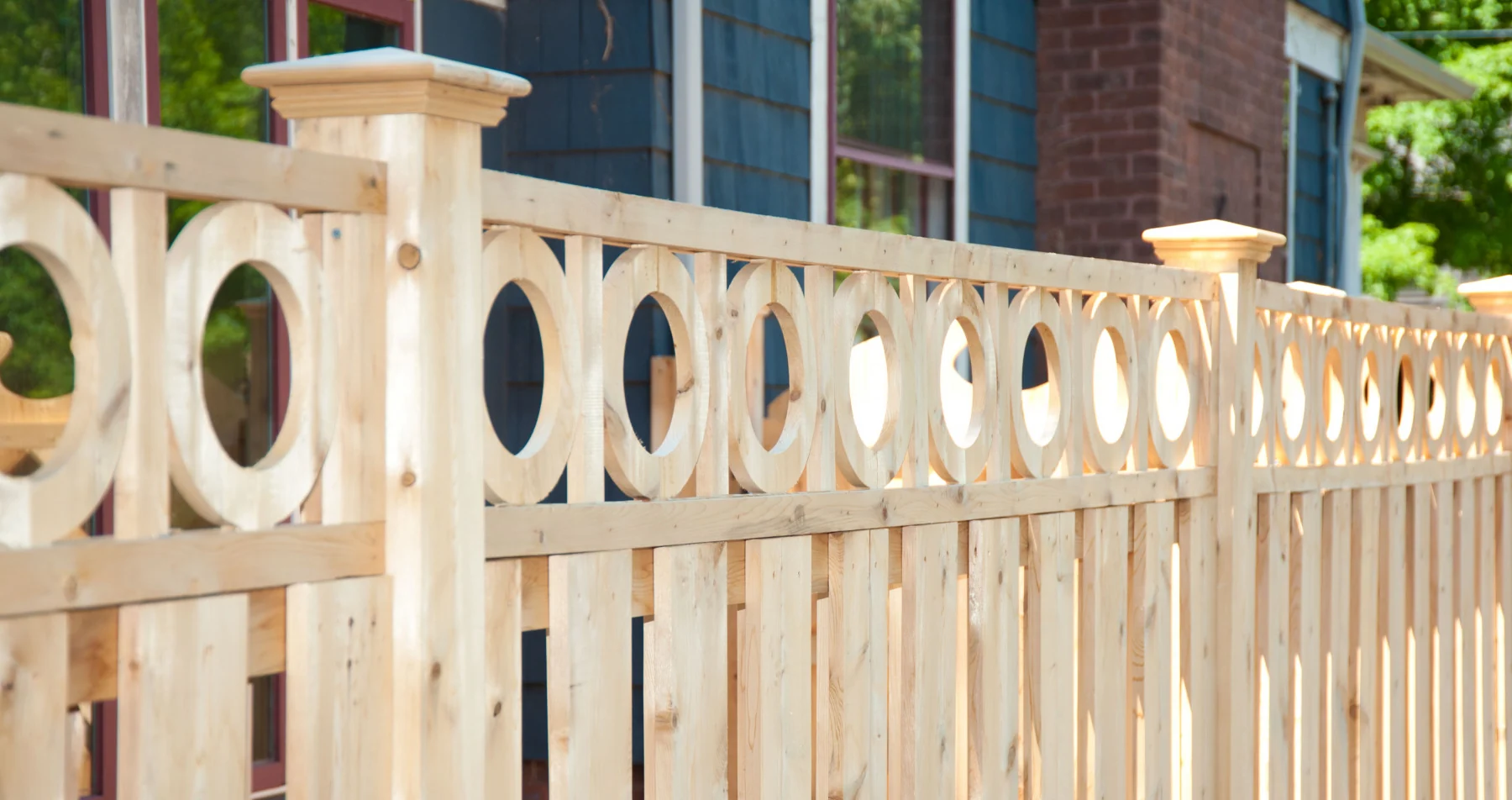 Eastern Wood Fence picket fence with circle cutout detail and post caps