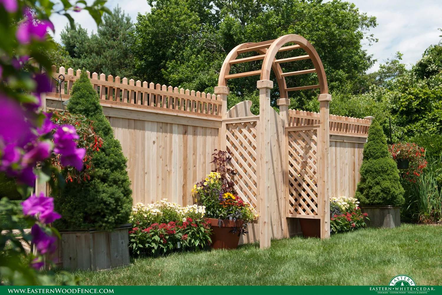 Eastern Wood Fence panels with a lattice arbor and flowers