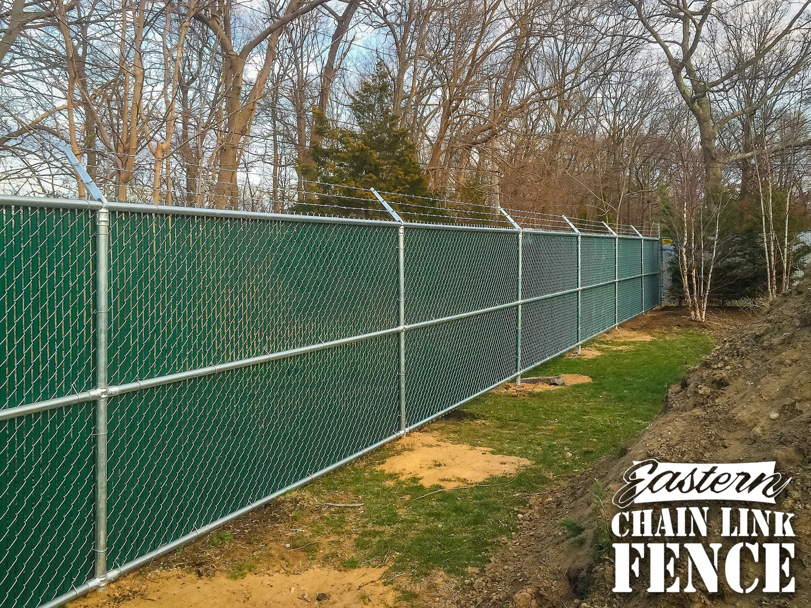 Galvanized chain-link with mid rail and green slats