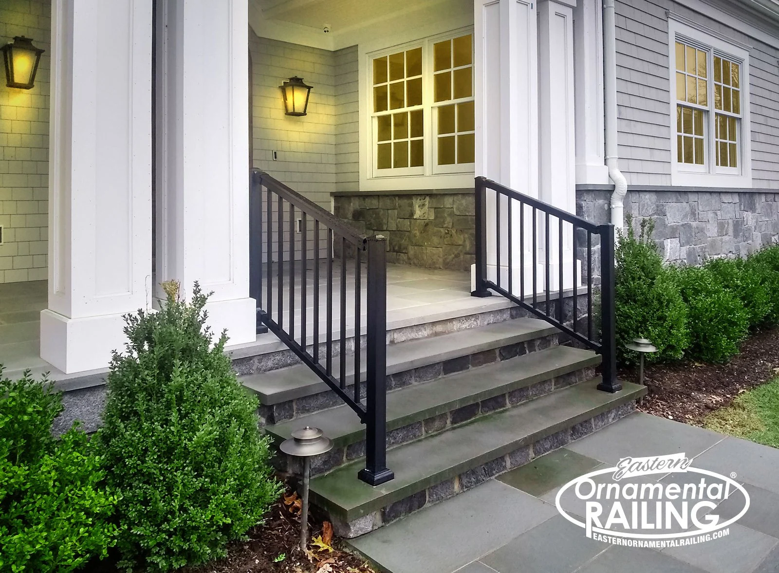 Black aluminum railing at a porch entry