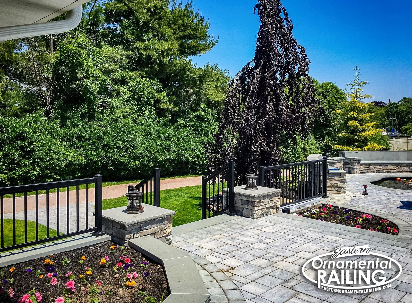 Aluminum railing at pool steps and stone wall