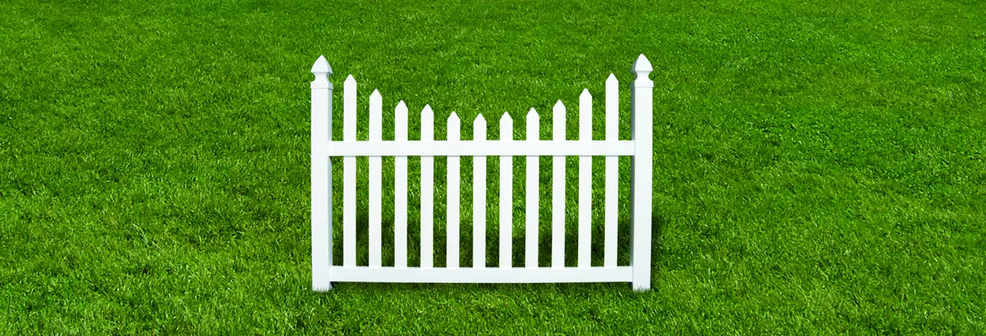 Envision scalloped white vinyl picket fence panel on grass