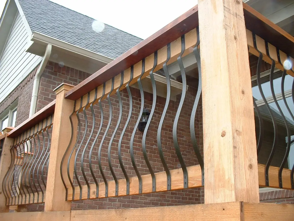 Fortress wide curved balusters in a log-style deck railing