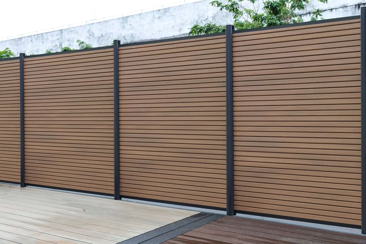 Riviera horizontal composite fence beside a deck