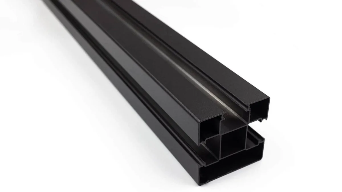 Black aluminum fence post with a slotted board channel