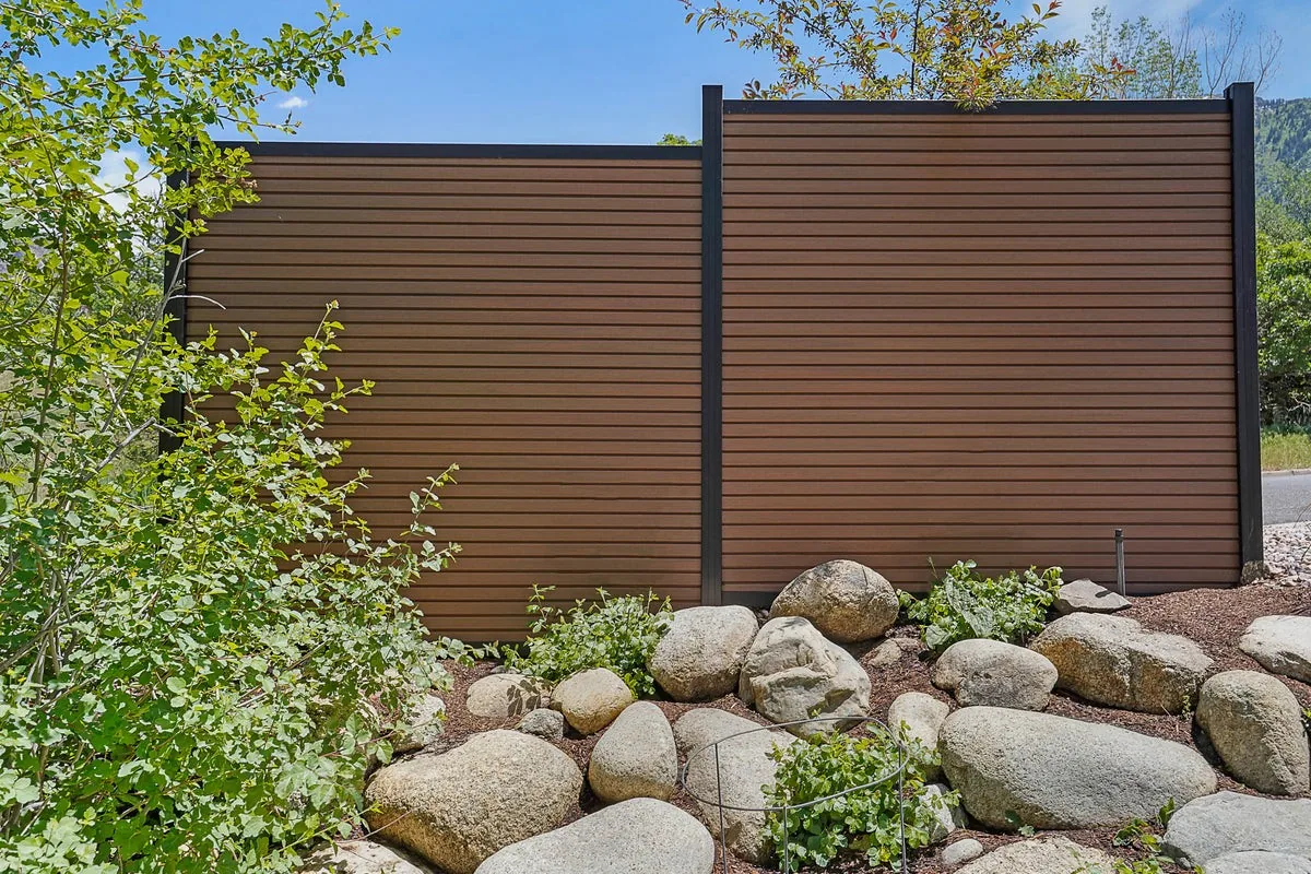 Riviera composite privacy fence panels in a mahogany color