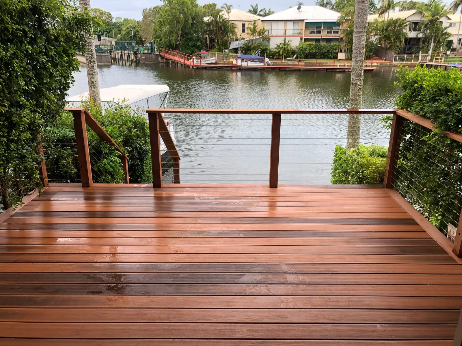 Cable railing on a hardwood deck by a pond