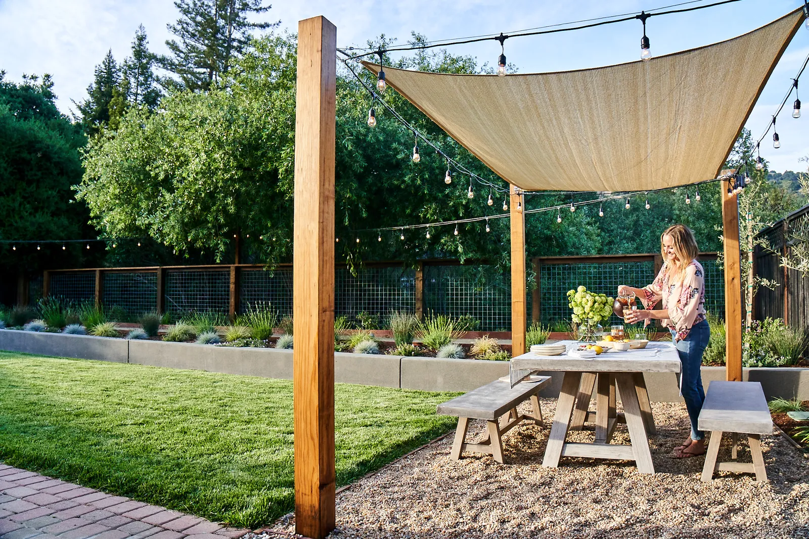 Shade sail over a backyard dining area