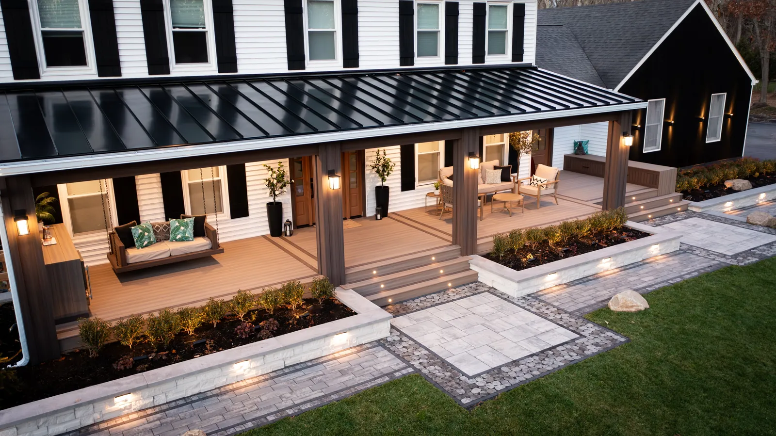 Low deck and patio along a dark-sided home