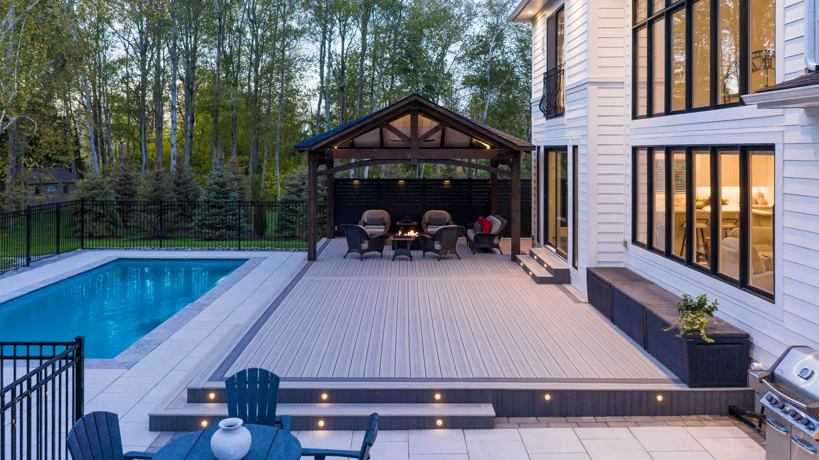 Pool deck with recessed lights and a covered pavilion