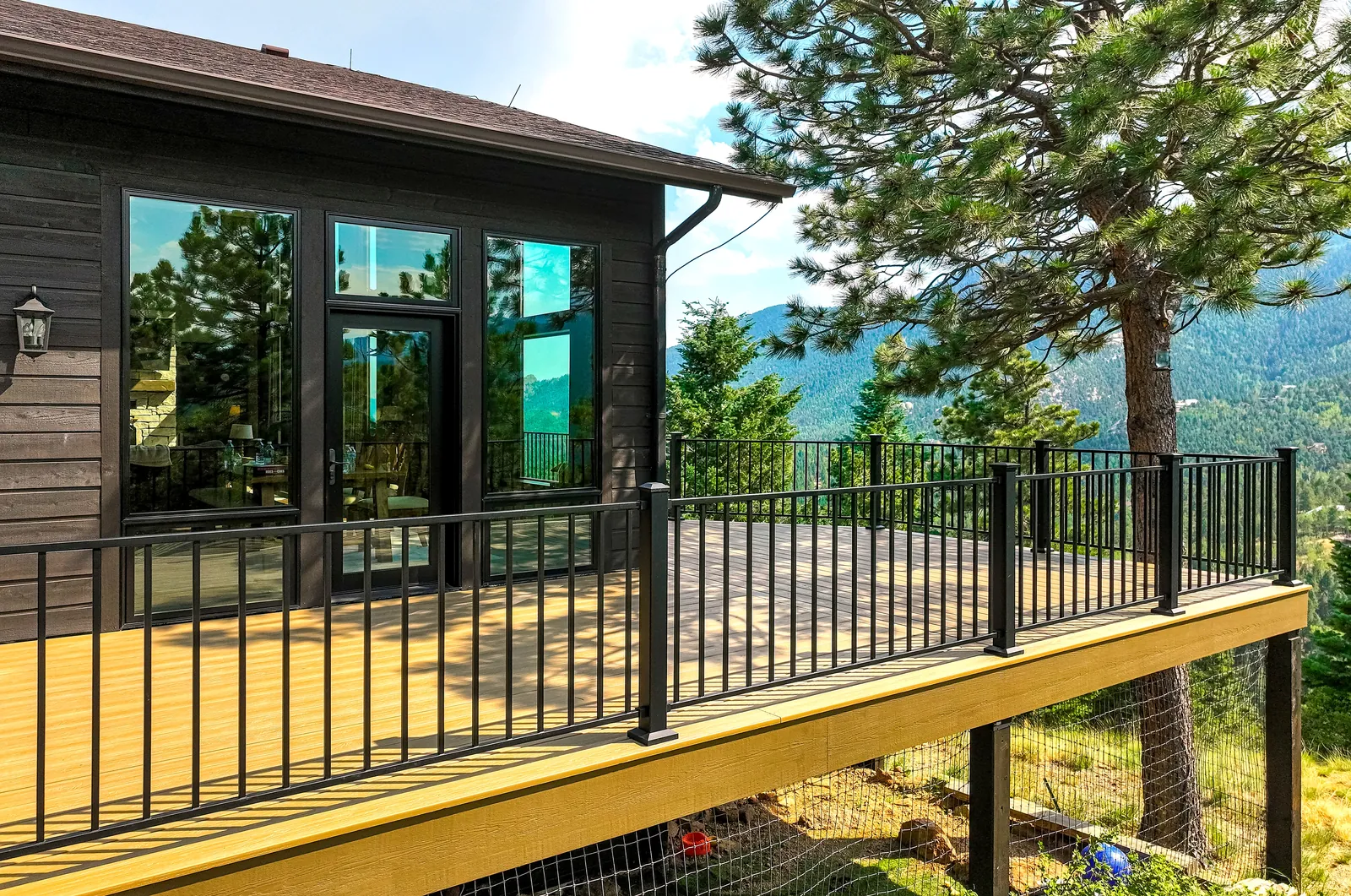 Elevated deck with black railing among the pines