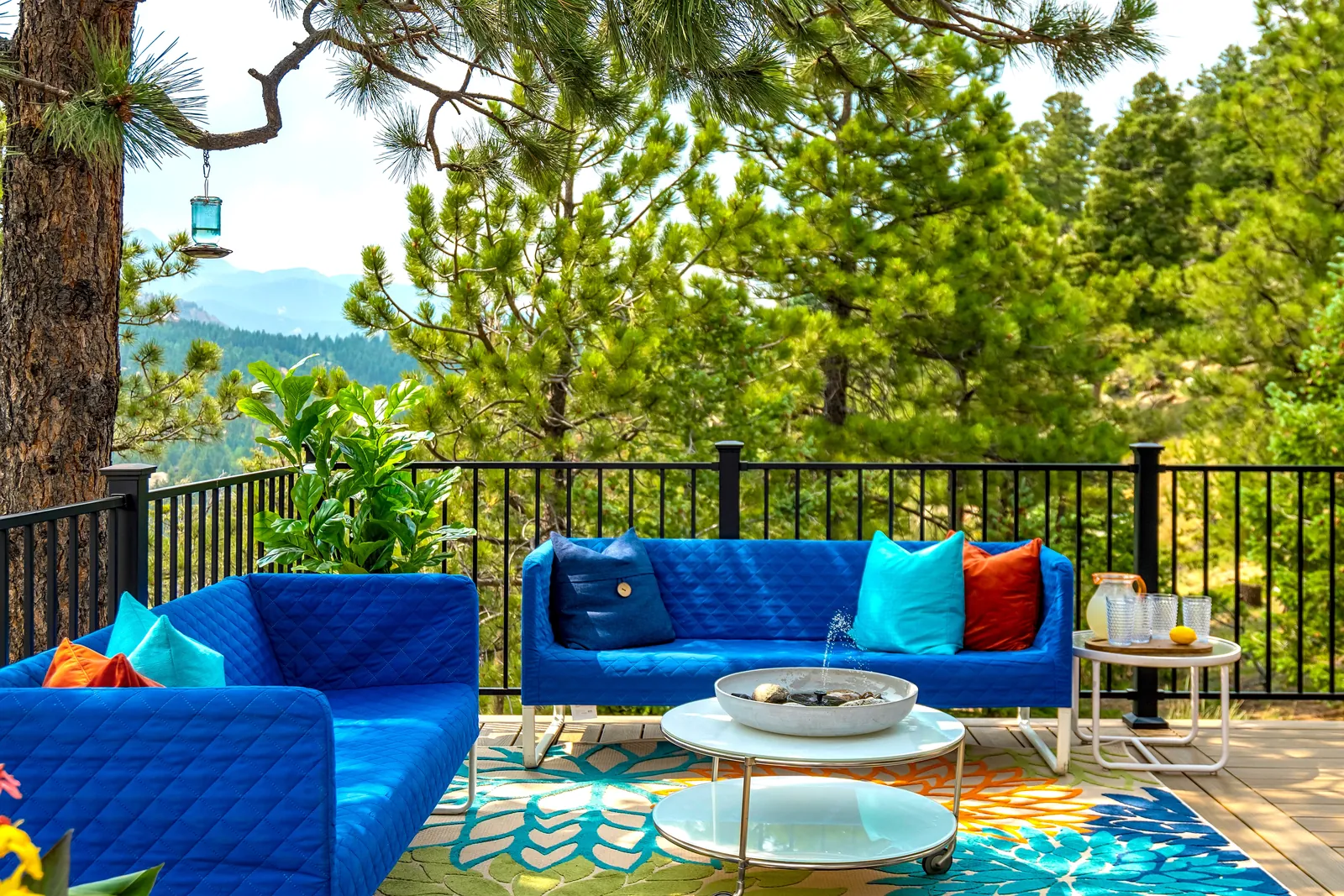 Mountain deck with black aluminum railing and bright outdoor furniture
