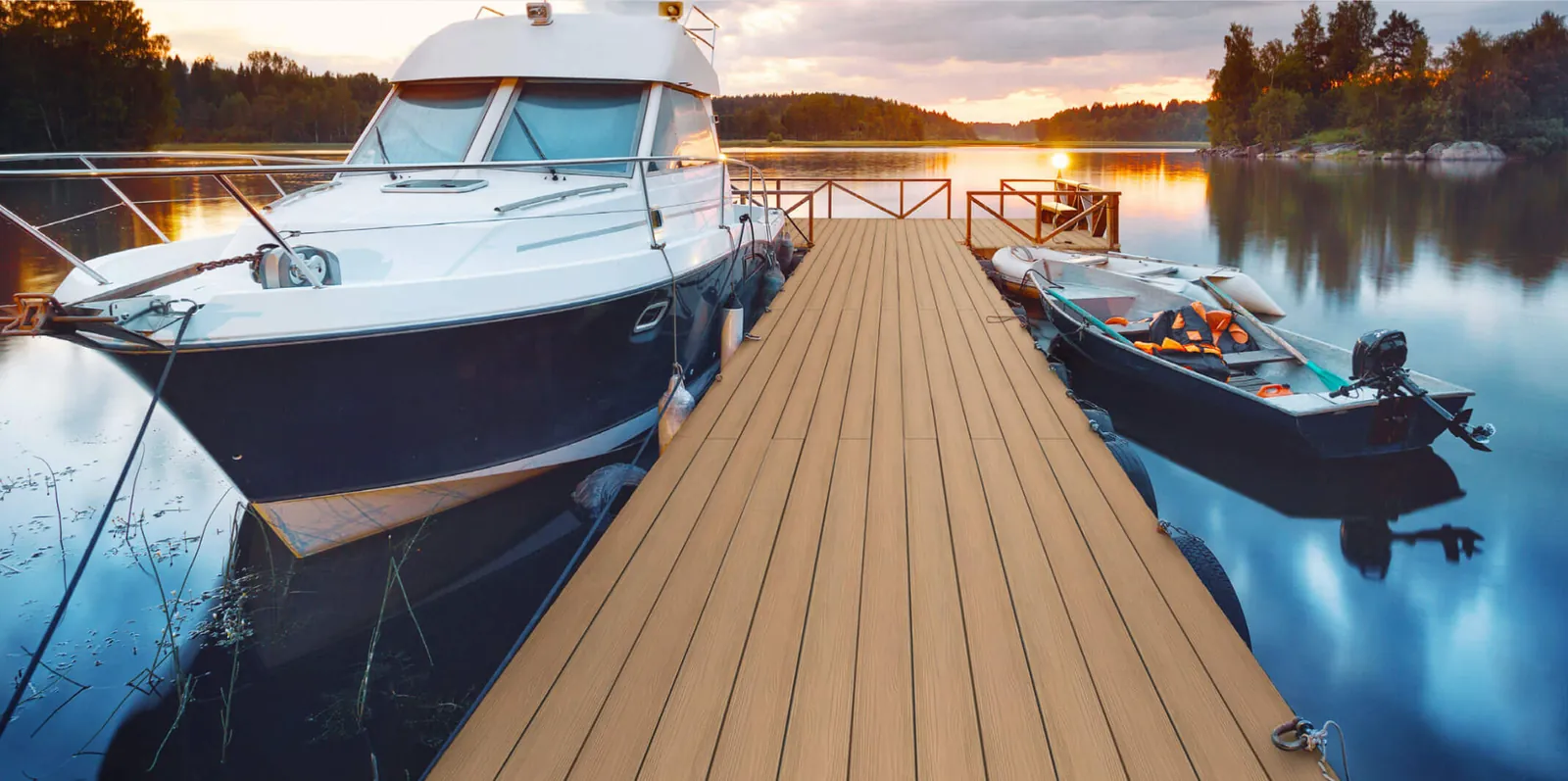 Lake dock with boats at sunset