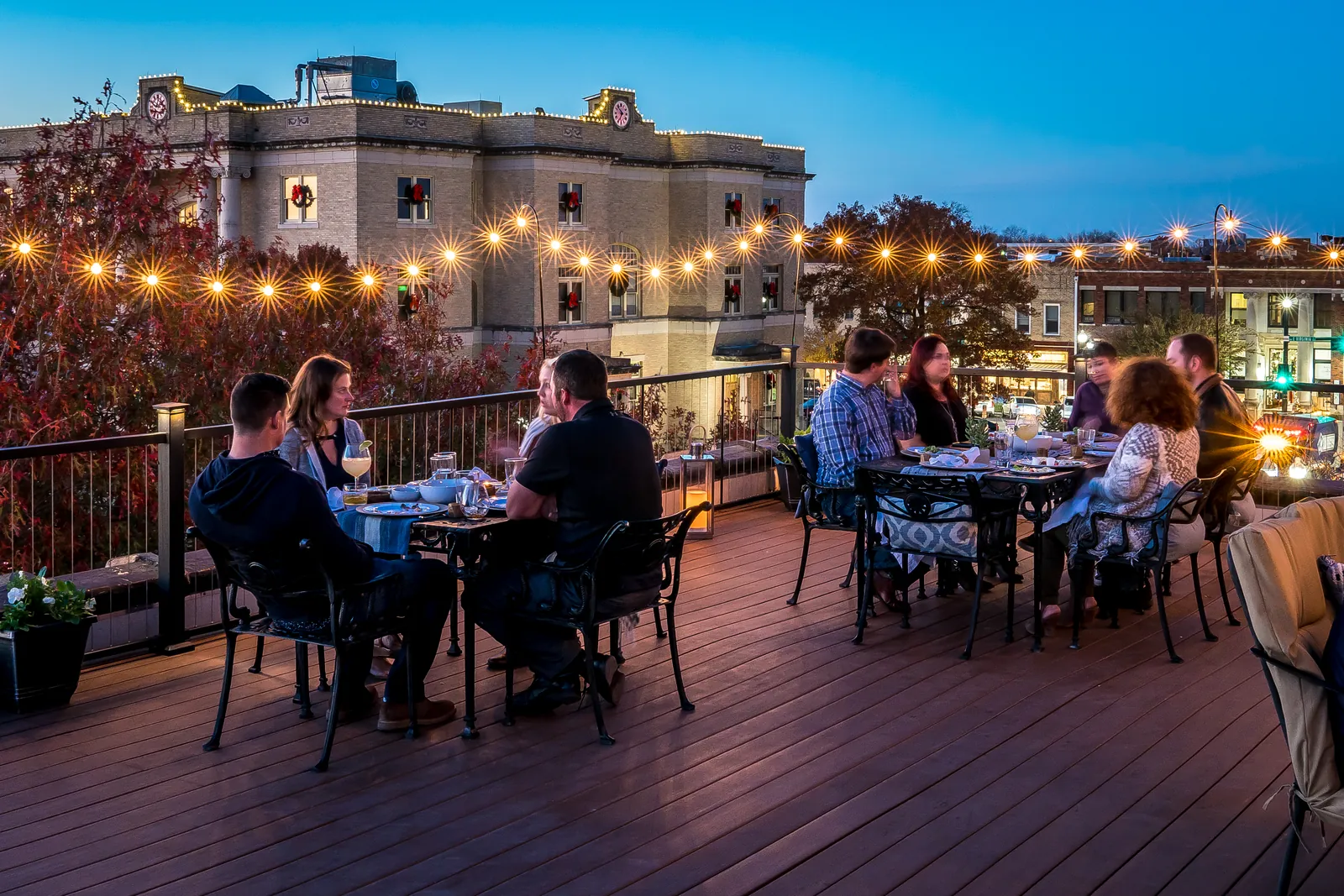 Rooftop restaurant deck with string lights at night