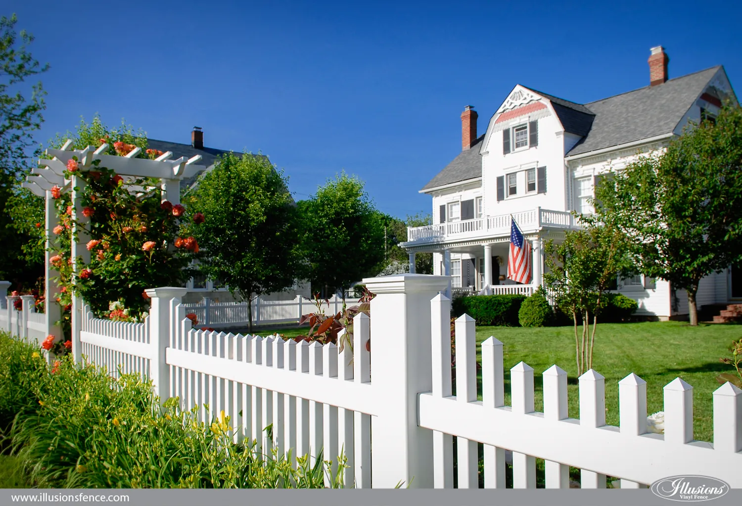 White vinyl picket fence with garden arbor