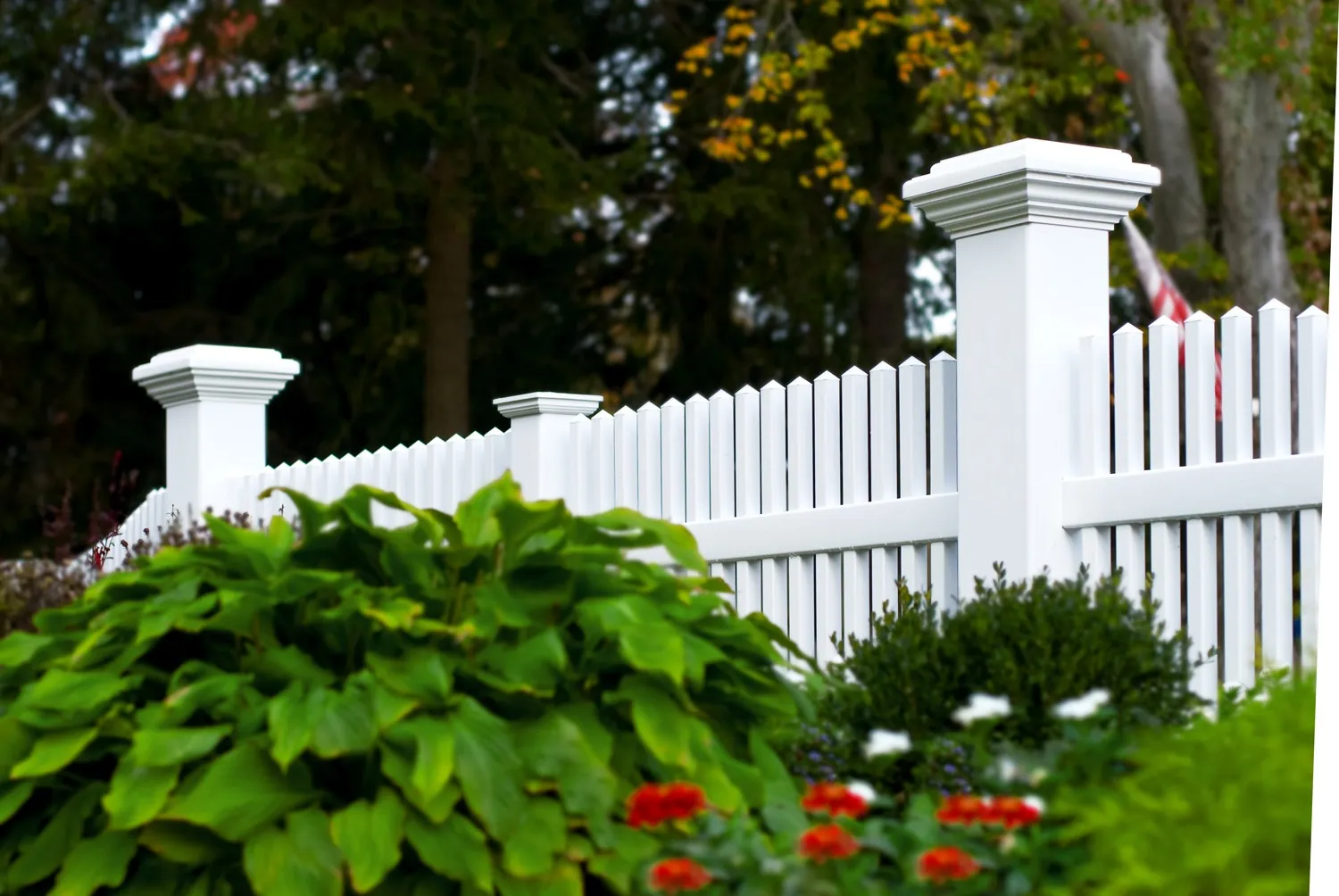 White vinyl picket fence with pillar posts