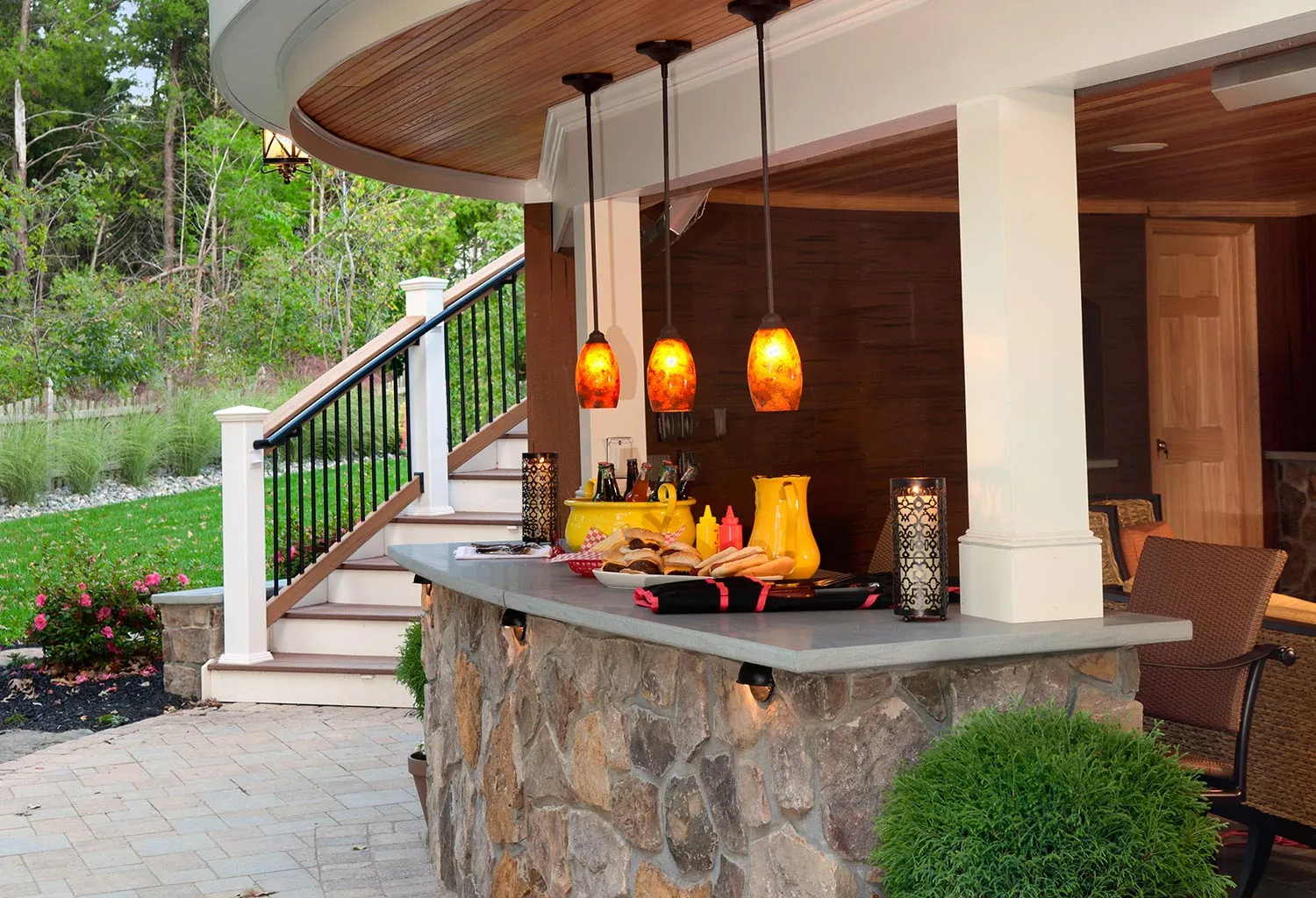 Deck with an outdoor bar and pendant lights