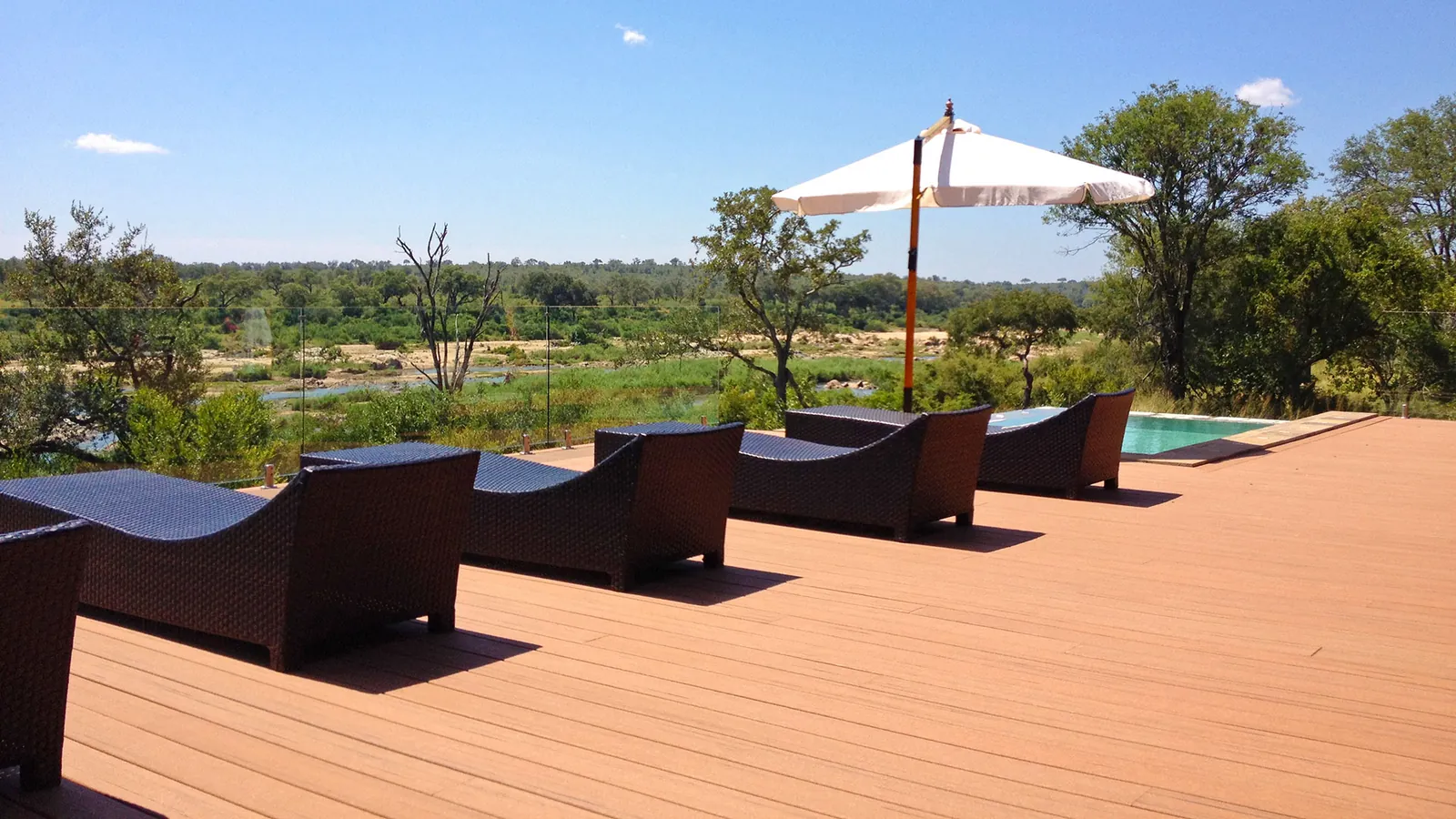 Long sun deck with loungers overlooking the water