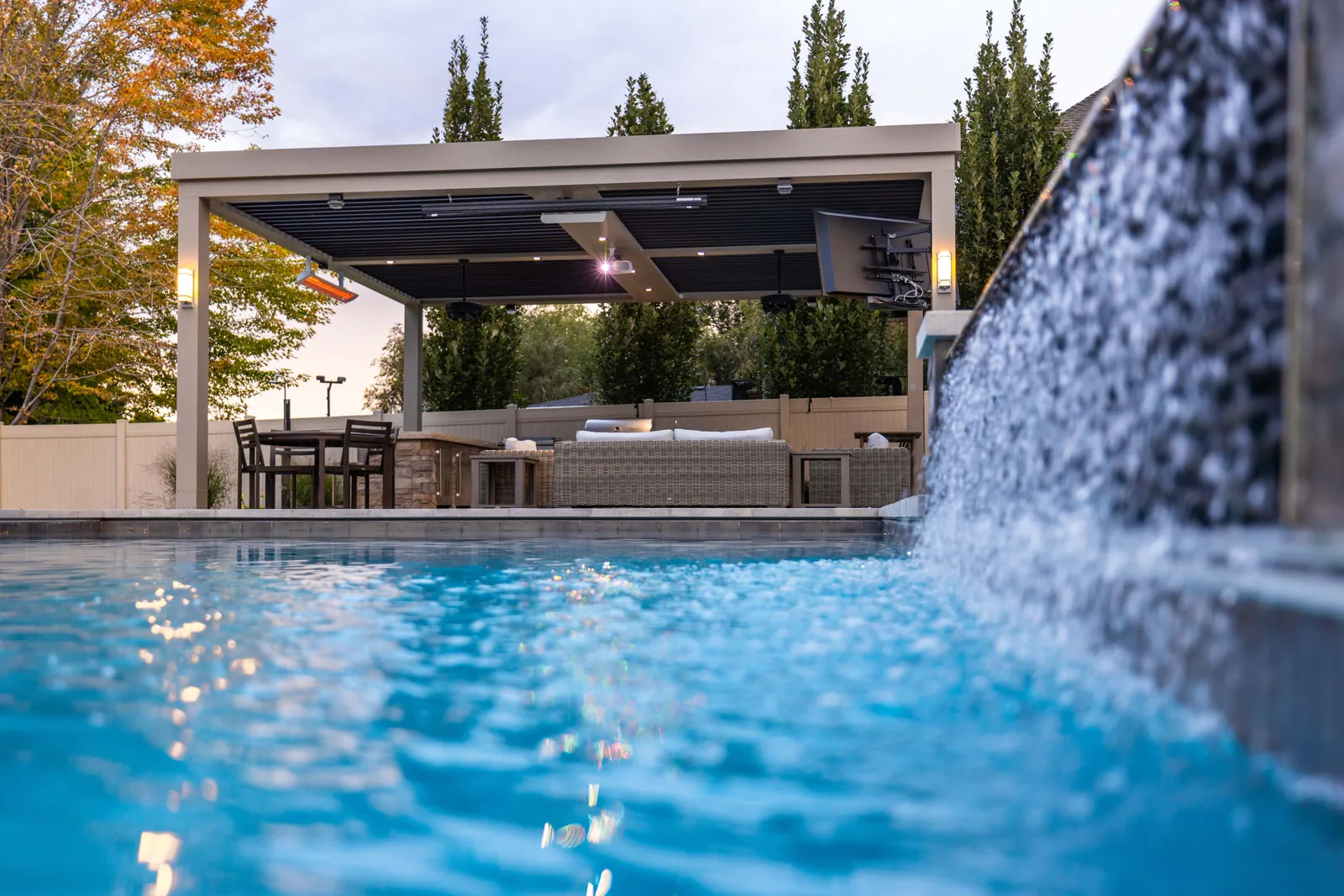 Pergola and water feature by a pool