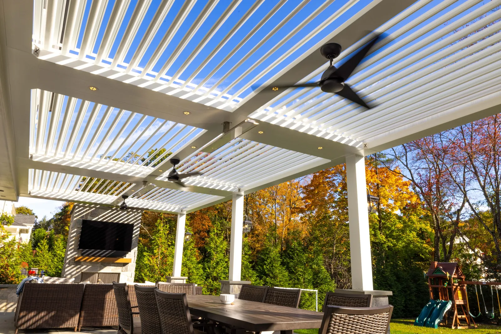 White louvered pergola over an outdoor living room