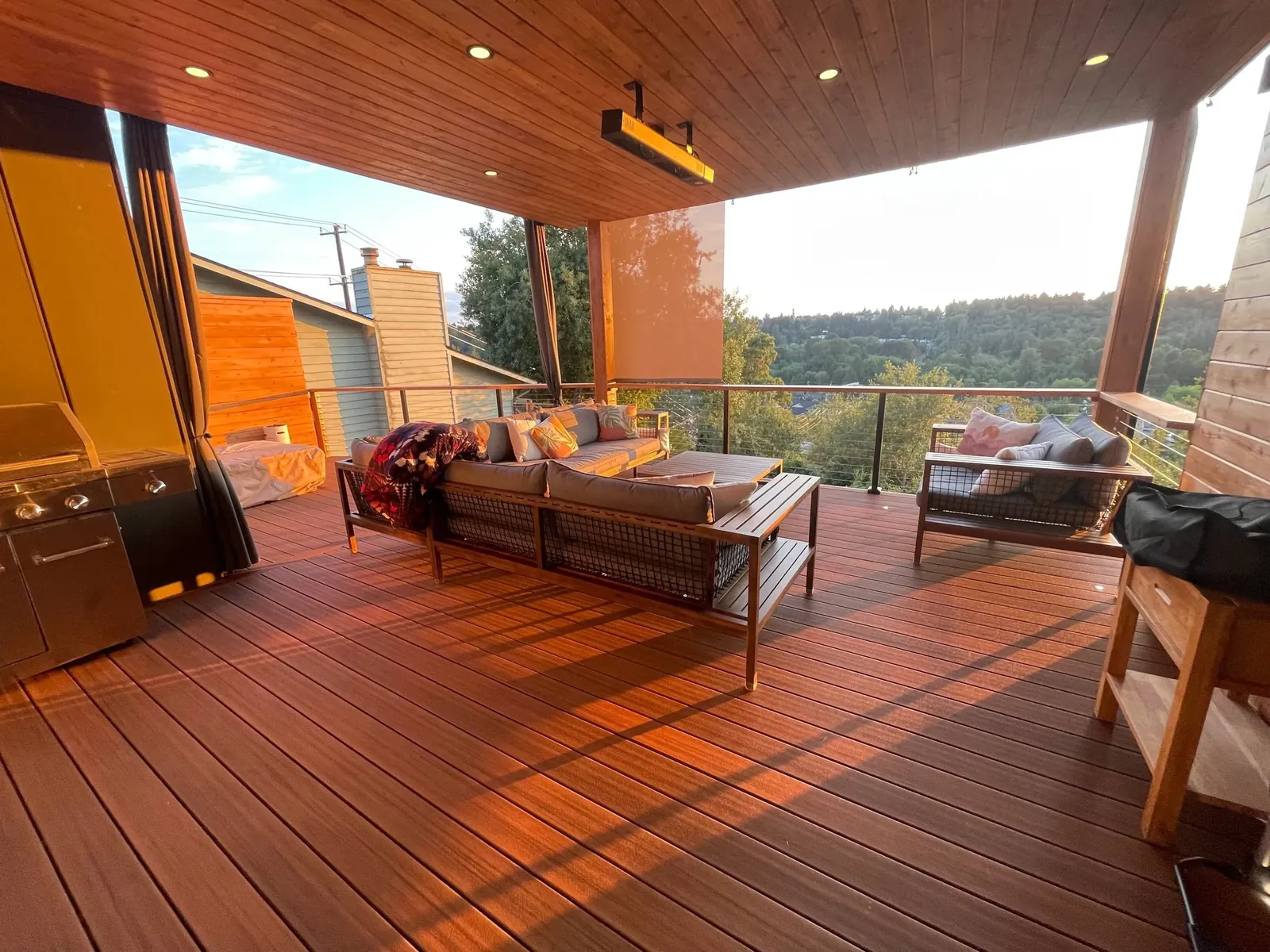 Covered deck with lounge furniture and lake view
