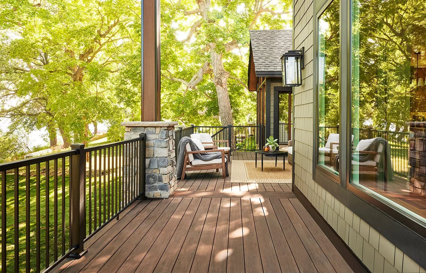Wraparound deck with black railing in the trees