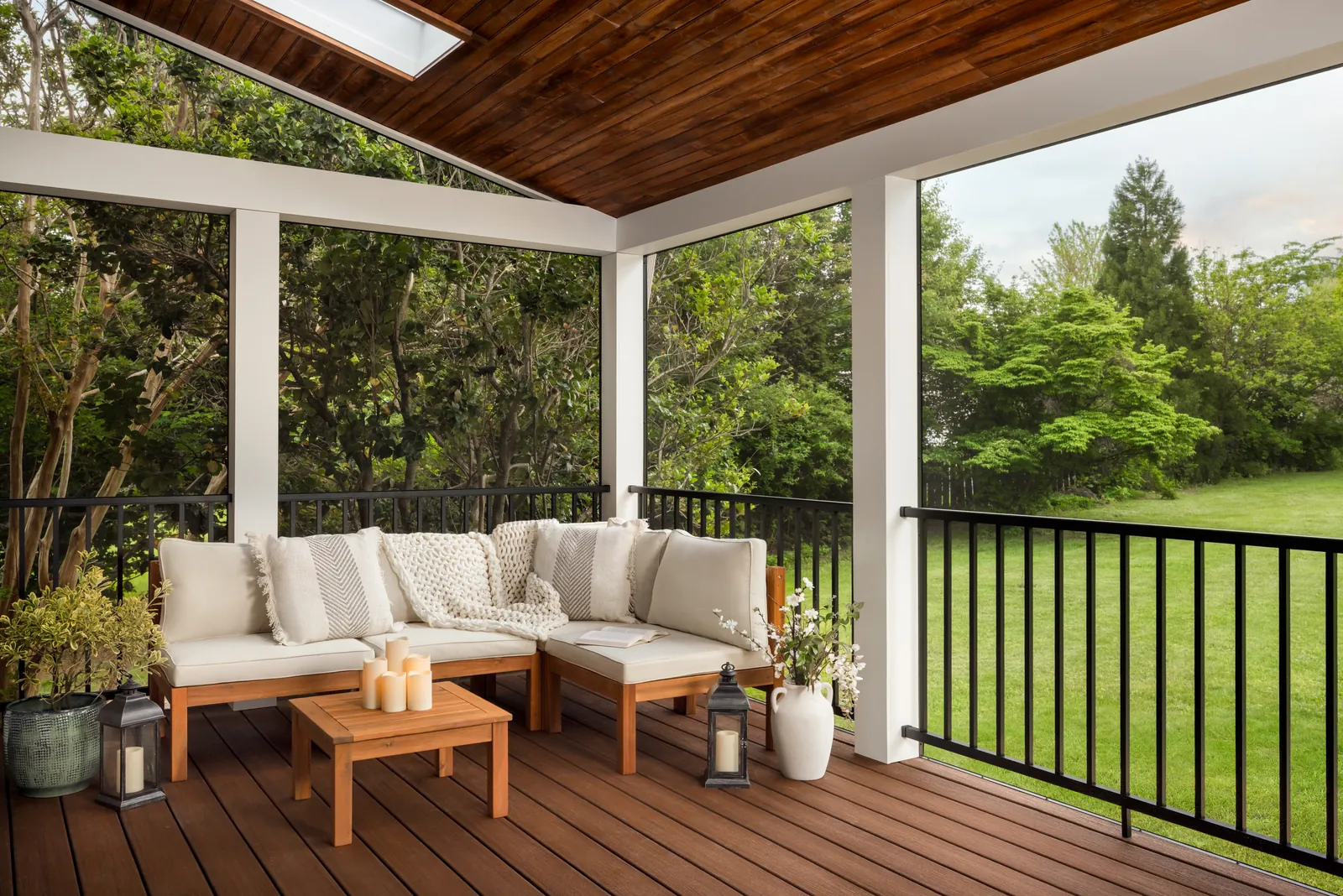 Covered deck with outdoor sectional and black railing