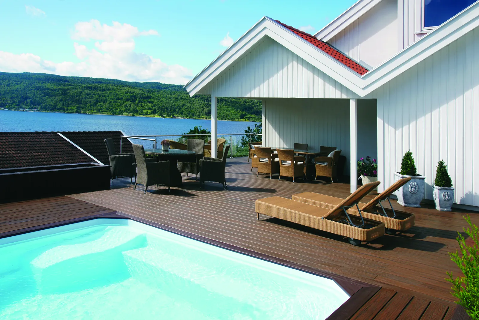 Waterfront pool deck with lounge chairs